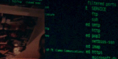 Nmap output scrolls past a security video feed.